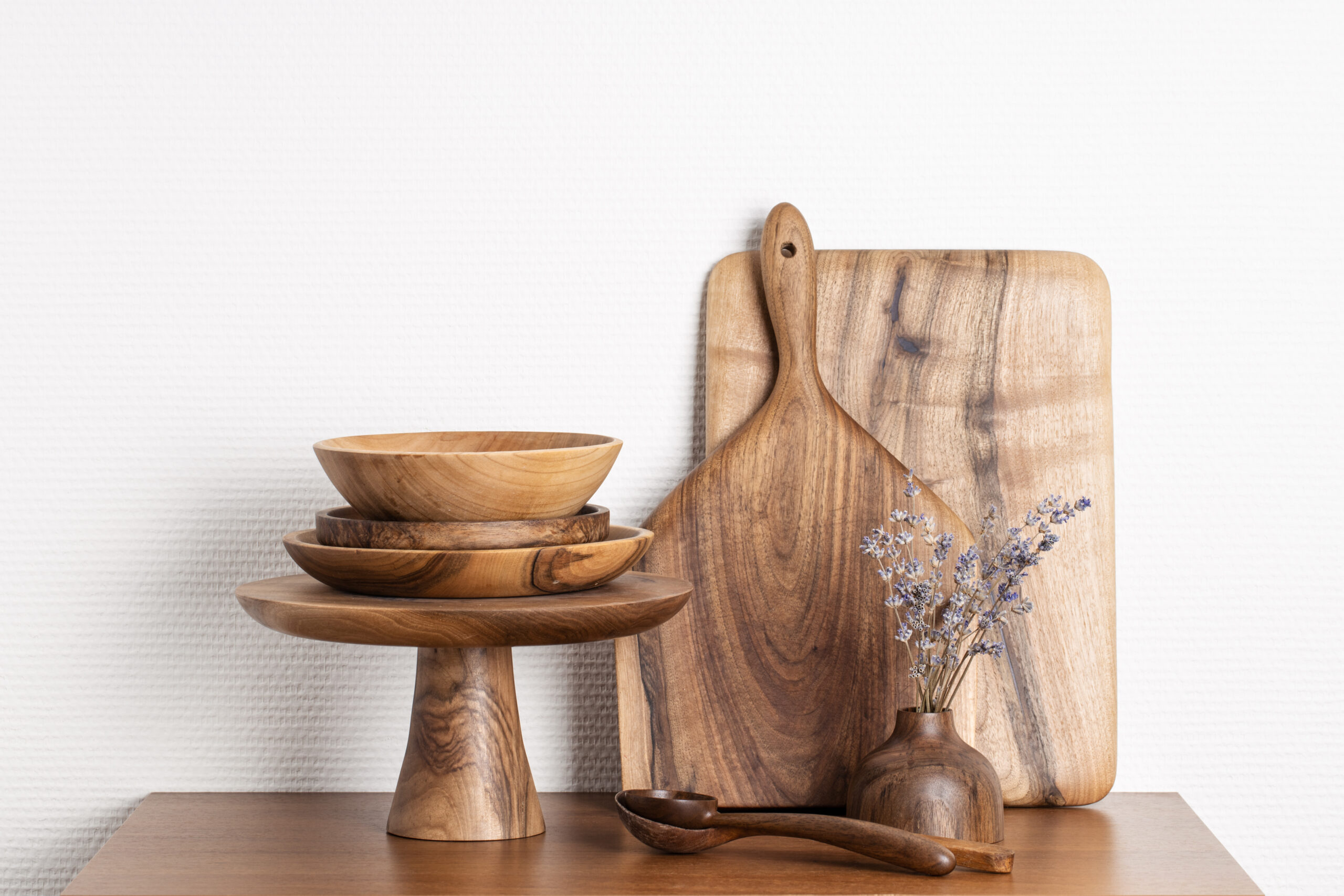 Wooden,Kitchenware,Against,White,Wall.,Boards,,Spoons,,Bowls,,Cake,Stand